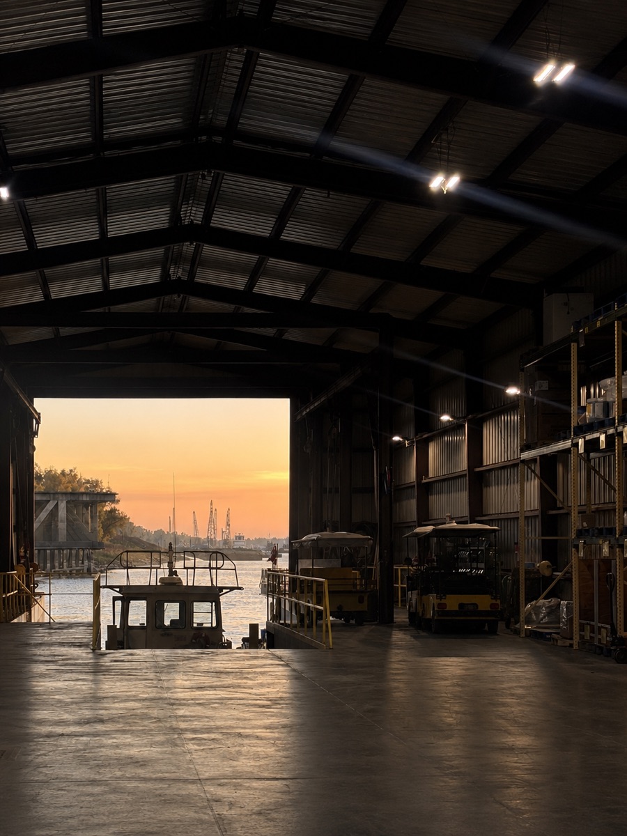 Warehouse interior at sunset with forklifts beside the loading dock